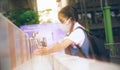 Asian student washing hands at the outdoor wash basin in the school. Preventing Contagious diseases, Plague. Kids health,