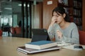 Asian student woman read books in library at university. Young girl stress tired have problem while study hard. Sadness concept Royalty Free Stock Photo