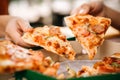 Asian students eating eating the pizza together Royalty Free Stock Photo