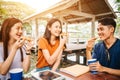 Asian students eating eating the pizza together Royalty Free Stock Photo