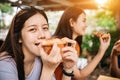 Asian students eating eating the pizza together Royalty Free Stock Photo