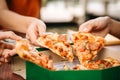 Asian students eating eating the pizza together Royalty Free Stock Photo