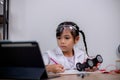 Asian students learn at home by coding robot cars and electronic board cables in STEM, STEAM, mathematics engineering science