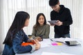 Asian students read books and use digital tablets to find information for work and online studies