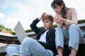 Asian students sitting on step are excited and stressed and disappointed after check exam results in computer laptops,