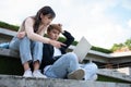 Asian students sitting on steps and use computer laptops to discuss before exams, Student lifestyle at university. Group of Royalty Free Stock Photo