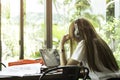 Asian students in uniform with headphone studying in coffee shop