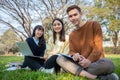Asian students use notebook computers and tablet to work and study online in the garden at home Royalty Free Stock Photo