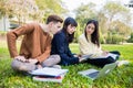 Asian students use notebook computers and tablet to work and study online in garden at home during the coronavirus epidemic and Royalty Free Stock Photo