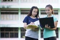 Asian students are using a taplet to check their grades. Royalty Free Stock Photo