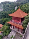 Asian style ancient pagoda building on a hillside among the trees Royalty Free Stock Photo