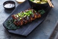 Asian style Barbecue pork ribs honey glazed on wooden board, top view