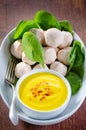 Asian style meatballs in a bowl with saffron and yogurt sauce