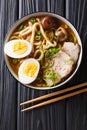 Asian style soup with udon noodles, pork, boiled eggs, mushrooms