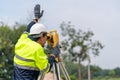 Asian Surveyor Civil Engineer working theodolite or total positioning station on the construction site
