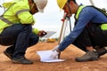 Asian surveyor engineer two people checking level of soil to measure leveling for cut and fil