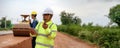 Asian surveyor engineers use tablet to check detail in job, Control schedule of work of highway road construction projects with