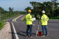 Asian surveyor engineers worker making measuring with theodolite instrument equipment during construction road works, Civil