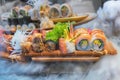 Asian sushi menu with dry ice smoke. Special presentation of Japanese food