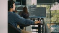 Asian system engineer working with html script on computer screen Royalty Free Stock Photo