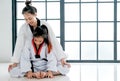 Asian Taekwondo teacher and student are action to get muscle relaxation by different posture before and after training