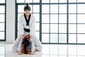 Asian Taekwondo teacher and student are action to get muscle relaxation by different posture before and after training