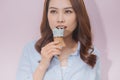 Asian Tan Skin Girl holding Icecream cone in her mouth Royalty Free Stock Photo