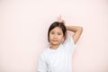 Asian tanned skin girl child portrait over pink wall background