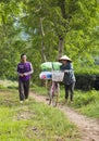 Asian tea farmers carrying packages of tea from the hill to the tea factory