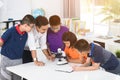 Asian teacher expanding to student in biology class with microscope . Royalty Free Stock Photo