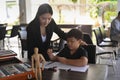 Teacher helping her student drawing in art class. Royalty Free Stock Photo