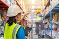 Asian teamwork of Foreman and female laborer working in a warehouse. Working Woman Concept