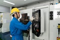 Asian technician engineer operating CNC machine in workshop Royalty Free Stock Photo