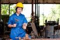 Asian technician girl use hammer to work with wood in the workplace during day time