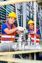 Asian Technicians or engineers working on valve Royalty Free Stock Photo