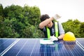 Asian technicians install panels Solar cells to produce and distribute electricity.