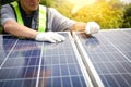 Asian technicians install panels Solar cells to produce and distribute electricity.