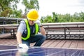 Asian technicians install panels Solar cells to produce and distribute electricity.