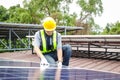 Asian technicians install panels Solar cells to produce and distribute electricity.