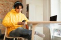 Asian Teen Boy Using Mobile Phone Wearing Headphones At Home Royalty Free Stock Photo