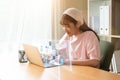 Asian teen girl using laptop computer study online during the covid-19 outbreak situation, Education technology at home concept Royalty Free Stock Photo