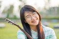 Asian teen girls with a guitar at the shoulder in the lawn. She is wearing braces and wear eyeglasses. Royalty Free Stock Photo