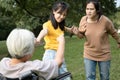 Asian teen granddaughter dissuade her family from a big fight,angry senior mother ,aggressive daughter arguing violently,abusing, Royalty Free Stock Photo