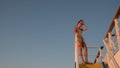 Asian teen standing on top of blue stair with yellow stripe Royalty Free Stock Photo