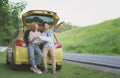 Asian teenage couples parked on the roadside, search for tourist spots on the map.