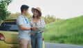 Asian teenage couples parked on the roadside, search for tourist spots on the map.