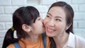 Asian teenage daughter kissing mother, showing love between mother and daughter Royalty Free Stock Photo