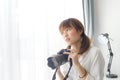 Asian Teenage girl with digital camera at home Royalty Free Stock Photo