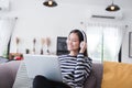 Asian teenage girls are happily listening to music from headphones,Asian girls relaxing by listening to music in the coffee shop Royalty Free Stock Photo