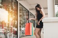 Asian teenage girls standing and holding shopping bags at shopping mall Royalty Free Stock Photo